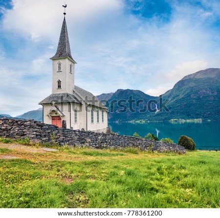 Wonderful summer view of Nes Church,  parish church in Luster Municipality in Sogn og Fjordane county, Norway. Splendid morning scene of village of Nes, on the western shore of the Lustrafjorden.