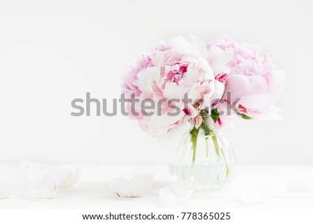 Fresh bunch of pink peonies on light background. Card Concept, copy space for text