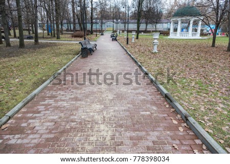 Path from stone tiles for pedestrian walks in a modern city park