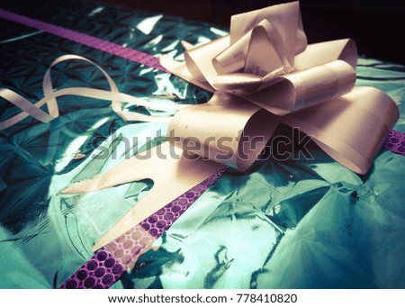 closeup of bow and ribboned gift ( gifting celebration)