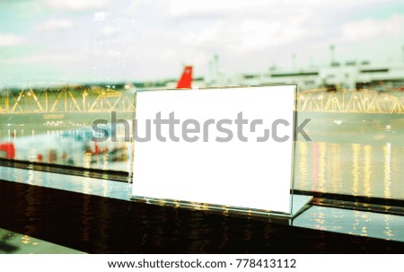 Mock up white Label on table for blank menu frame in restaurant in ariport, Stand for acrylic tent card Used for Menu Bar, blur of light background insert for text of customer.
