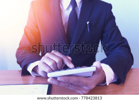 Business concept, young man using calculator for money.