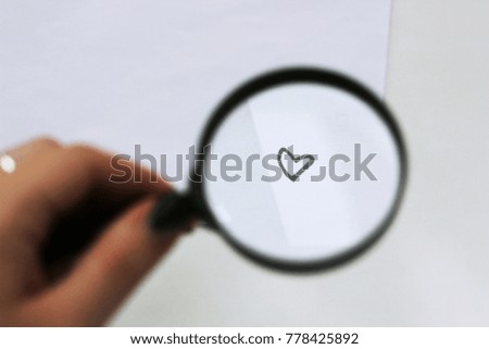 Little love, heart in a magnifying glass
