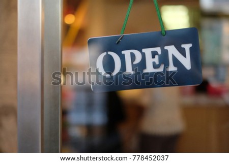 closeup open sign front of shop