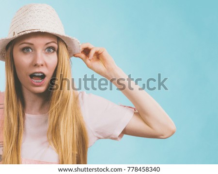 Shocked teenage young woman ready for summer wearing pink outfit and sun hat having surprised face expression