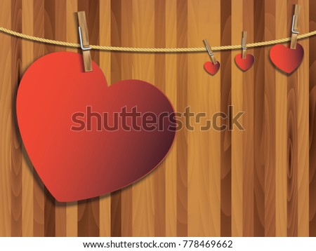 Red heart paper art with wooden clip and rope. Heart shape on wooden background for love concept. Concept of love for valentine day.
