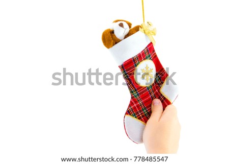Hand holding decorative christmas sock on white.