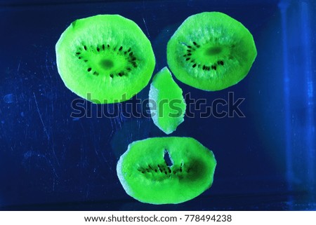 The face made by dried kiwi slices on black background