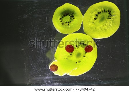The face of mouse made by dried kiwi slices and candy