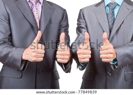 Two elegant businessmen standing and holding hands with thumbs up gesture, dressed in suit, shirt and tie. Concept Success, Approval, Good Work, isolated over white background.
