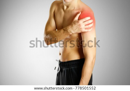 The guy with no shirt holding hand of the sore shoulder. The location of the pain marked in red.