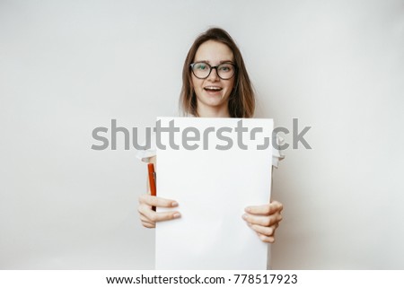 Woman shows a4 blank on a white background