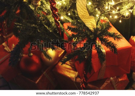 Merry Christmas and Happy New Year card, christmas tree decorations and presents under tree, close up shot