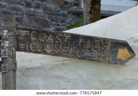 Signpost to Clovelly and South West Coast Path in the Seaside Village of Bucks Mill in Rural Devon, England, UK