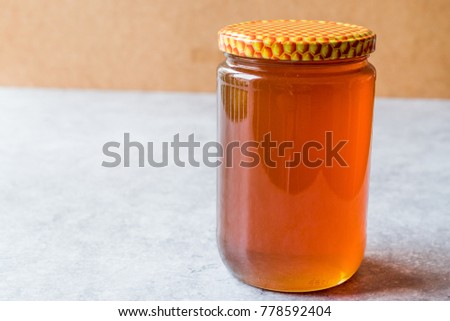 Honey in Jar with Lid. Copy Space.