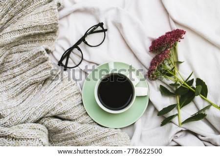 Notepad and cup of coffee on white background.