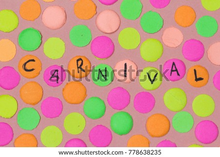 Hand written the word Carnival in each colorful confetti. Warm colors: pink, yellow and orange. Carnaval party background concept, space for text.