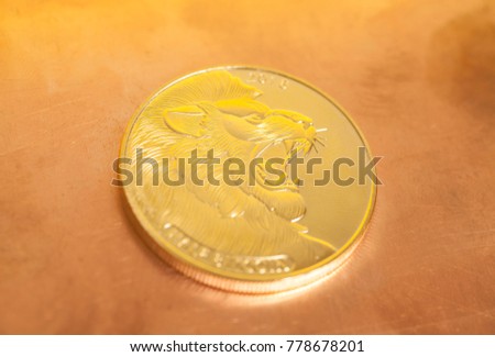 Half bitcoin with lion on a copper background