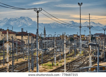 Cross railways and trains, in the background of city and mountains