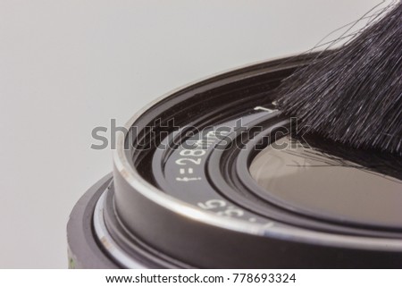 cleaning the lens with a brush