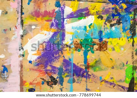 Abstract colorful painting on wood. Paint scratches, splashes, dots, stripes and squirts on plywood board. Creativity concept