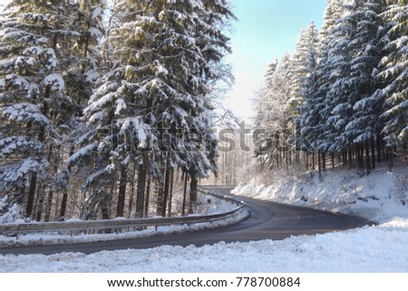 Winter weather, snow on the road. Snow calamity on the road, sunny day. Mountain pass Fackovske sedlo in Slovakia, Europe.