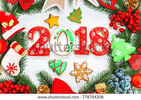 Christmas wreath with decorations, with gingerbread 2018, branch of Xmas tree on white background. A symbol of winter and new year holidays.