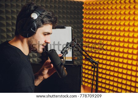 Microphone in radio studio and presenter on background