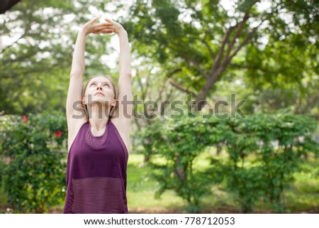 Serious Sporty Woman Stretching Arms and Body
