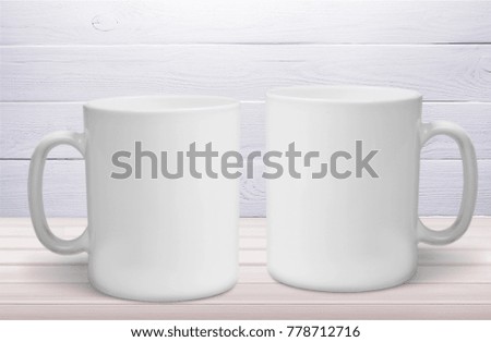 Two mugs on wooden table