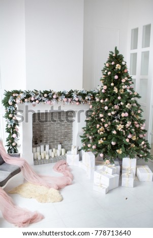 interior with fireplace decorated with candles, presents and pink toys for Christmas