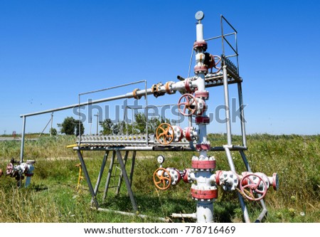 Well for oil and gas production. Oil well wellhead equipment. Oil production.