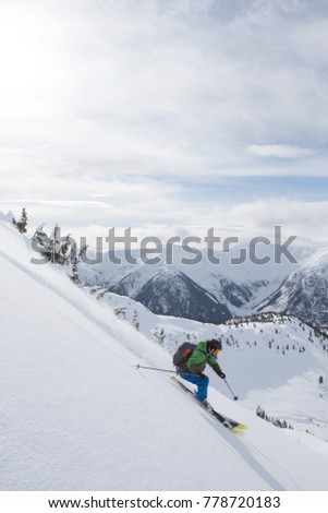 A young man skiing in the mountains near Terrace, British Columbia, Canada.