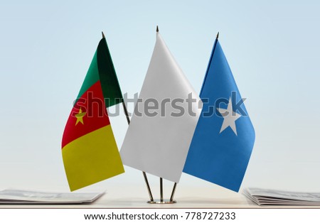 Flags of Cameroon and Somalia with a white flag in the middle