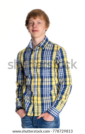 A young red-haired guy in a shirt and jeans. Isolated on white background.
