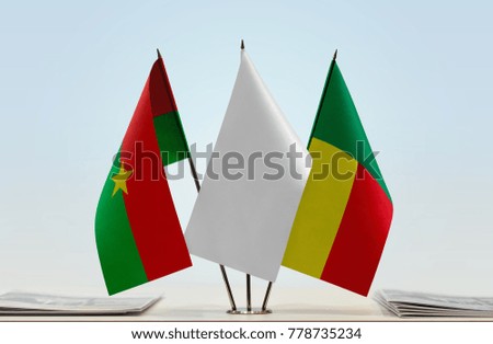 Flags of Burkina Faso and Benin with a white flag in the middle