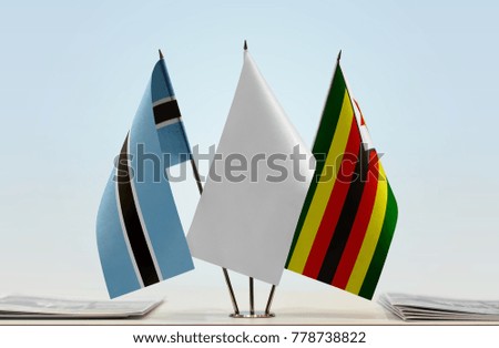 Flags of Botswana and Zimbabwe with a white flag in the middle