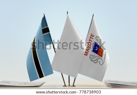 Flags of Botswana and Mayotte with a white flag in the middle