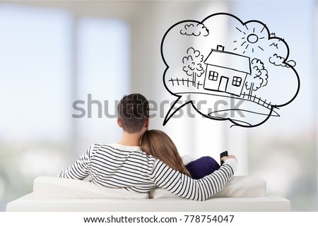 Young Couple Sitting On Sofa Royalty-Free Stock Photo #778754047