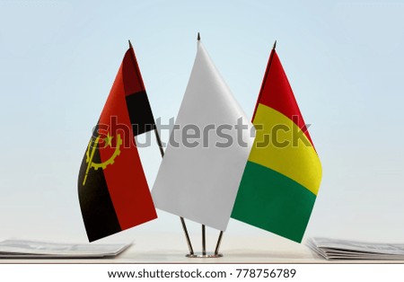 Flags of Angola and Guinea with a white flag in the middle