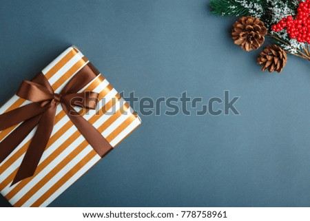 Christmas and New Year background with gifts, deer, stars and fir-trees, flat lay on a dark blue background, holiday greetings, concept of a winter background with free space