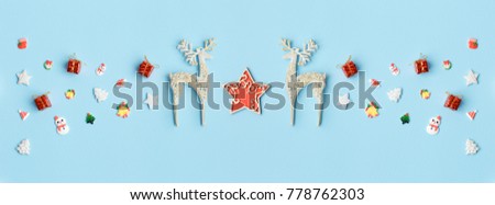 Christmas pattern with free space for text and gold Xmas deer and bells. Tree decoration. Happy New Year blue background. wide format image.