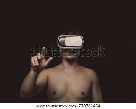 Man using  virtual reality headset over dark background