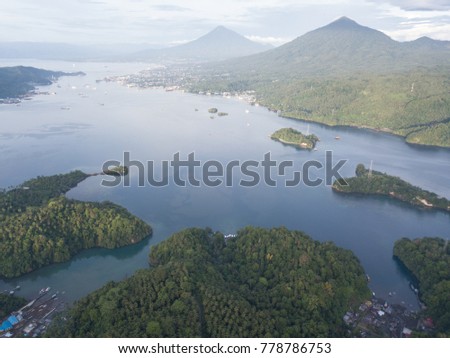 Clouds drift across Lembeh Strait in North Sulawesi, Indonesia. This stretch of water is known for its bizarre and amazing collection of tropical marine biodiversity. Royalty-Free Stock Photo #778786753