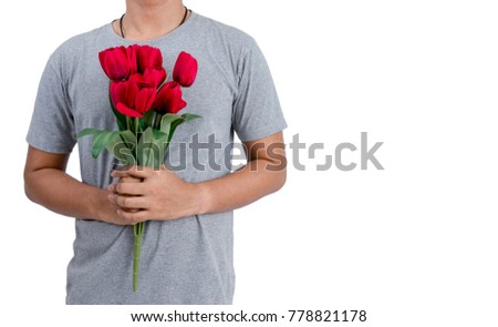 Isolated Asian young man holding the red tulip flower to give it to his girlfriend on Valentine's Day. Image contained clipping path.