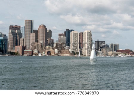 Sailing boats on the Charles River in front of Boston Skyline in Massachusetts USA on a sunny summer day