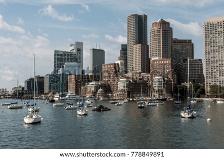 Sailing boats on the Charles River in front of Boston Skyline in Massachusetts USA on a sunny summer day