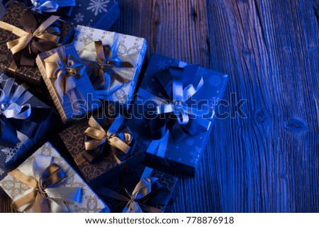 New years eve gift-giving. New years celebration. Presents on wooden table. Place for typography.