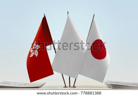 Flags of Hong Kong and Japan with a white flag in the middle