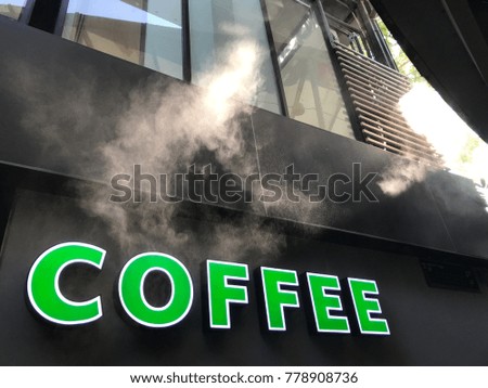 Green and white coffee lettering on cement wall with steam and morning sun And there is space for text or symbol and logo.